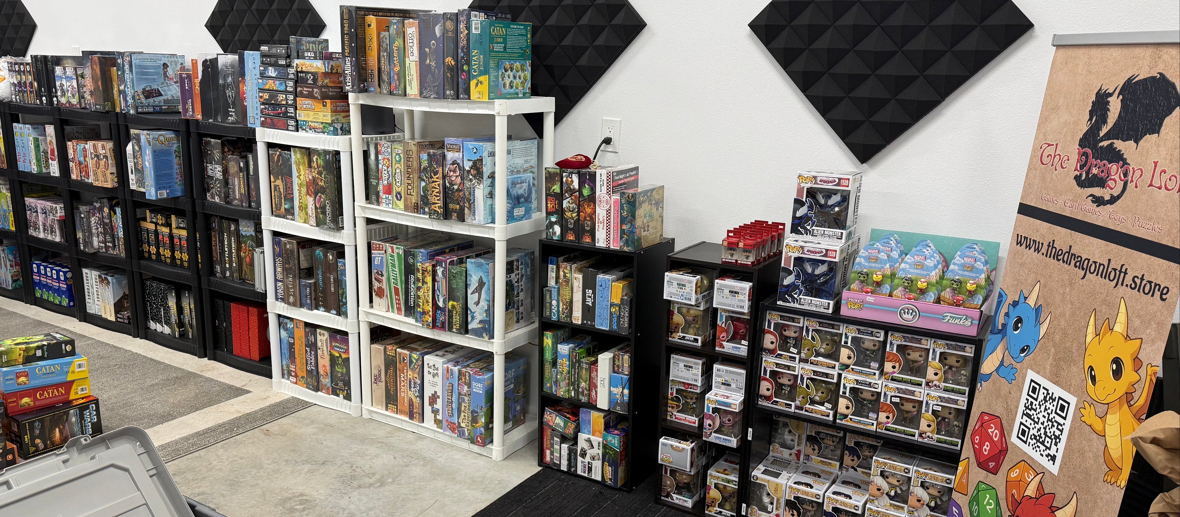 Storage room with shelves filled with various items, including books and boxes, against a white wall.